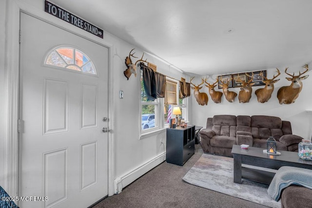 carpeted entrance foyer featuring a baseboard heating unit