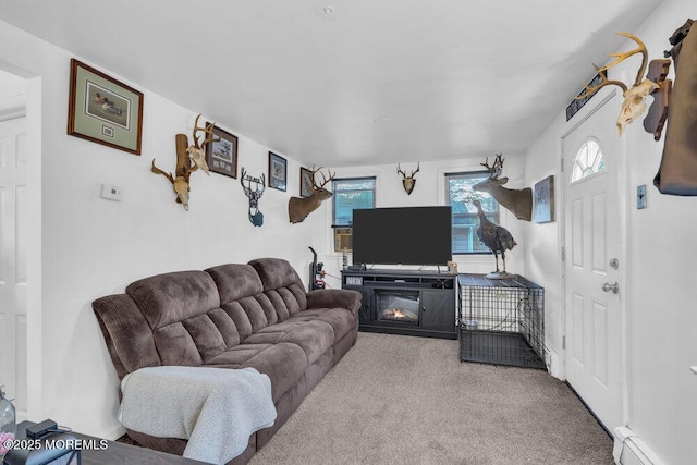 carpeted living room featuring a fireplace and a baseboard radiator