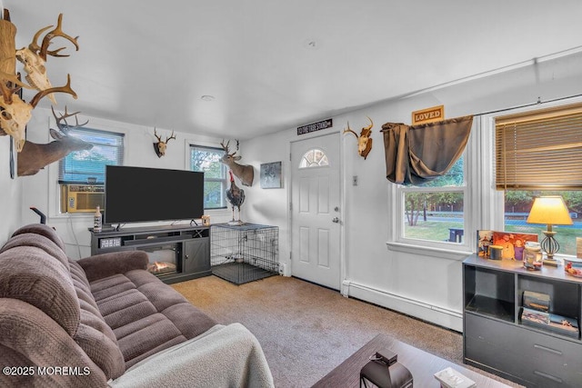 carpeted living room with cooling unit, a baseboard radiator, and a fireplace