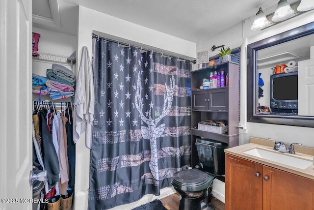 bathroom with toilet, walk in shower, wood-type flooring, and vanity