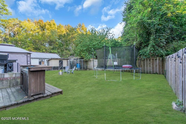 view of yard with a storage unit and a trampoline