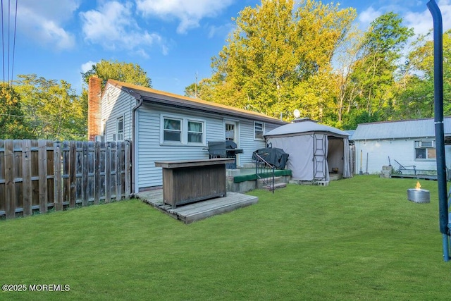 rear view of house with a gazebo and a lawn