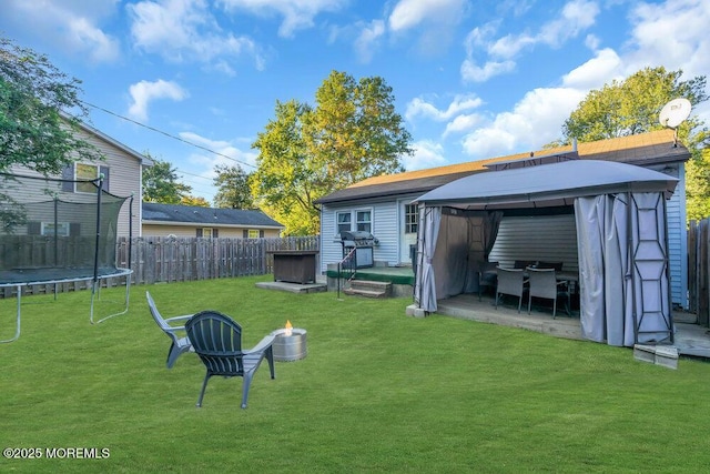 view of yard featuring a gazebo and a trampoline