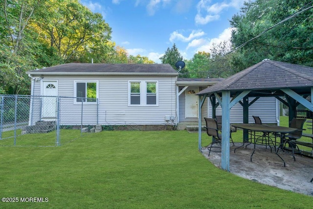 rear view of house with a lawn, a patio, and a gazebo