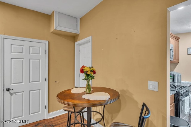 dining space with dark hardwood / wood-style flooring