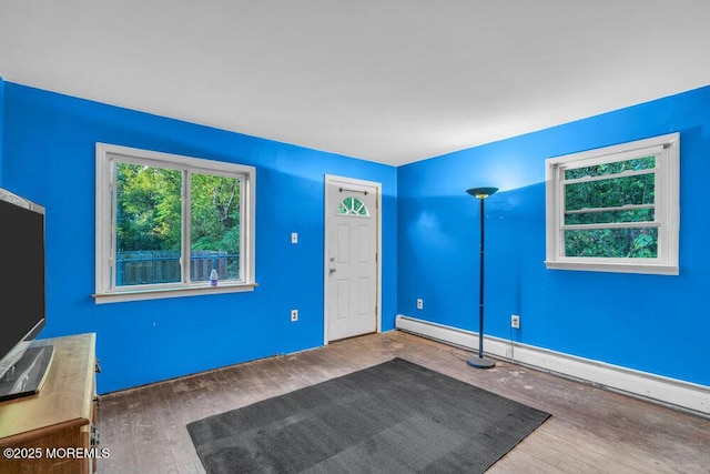 entrance foyer featuring hardwood / wood-style floors and baseboard heating