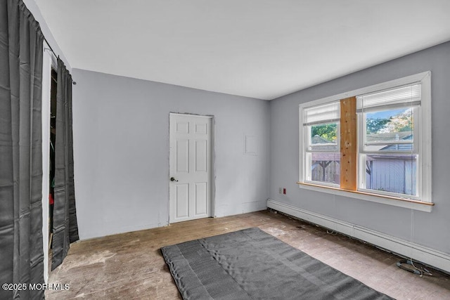 unfurnished bedroom featuring a baseboard radiator