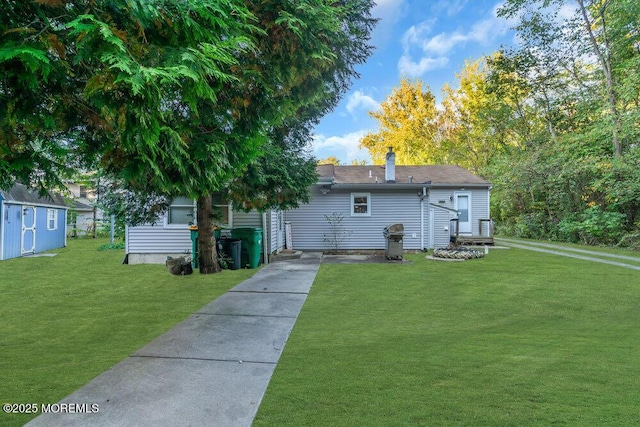 rear view of property featuring a lawn