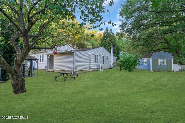 view of yard with a gazebo and a storage unit