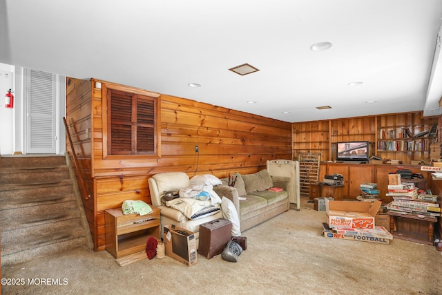 living room featuring carpet floors and wood walls