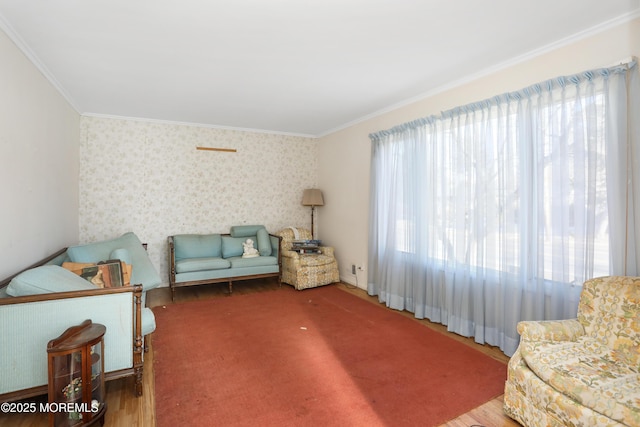 living area with crown molding and wood-type flooring