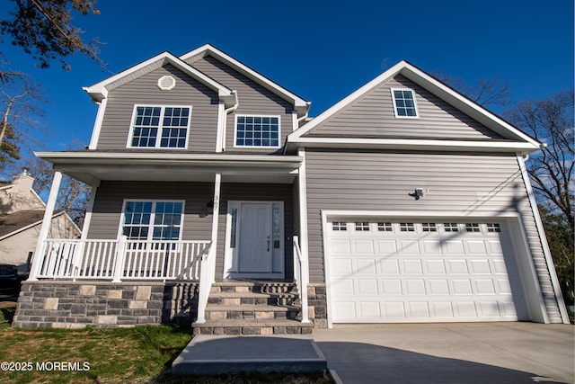 view of property featuring covered porch and a garage