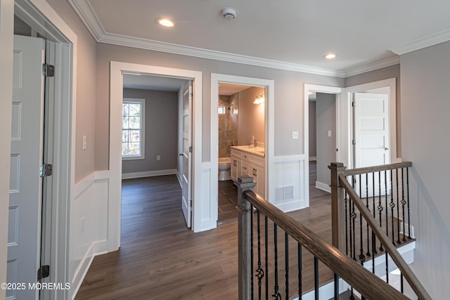 hall with dark hardwood / wood-style floors and crown molding