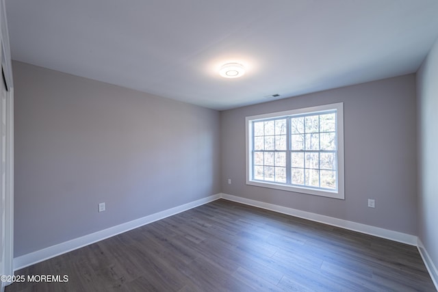 empty room featuring dark wood-type flooring