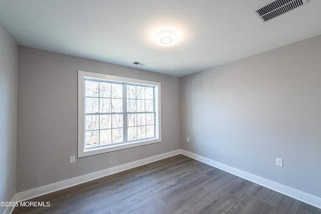 unfurnished room with dark hardwood / wood-style flooring