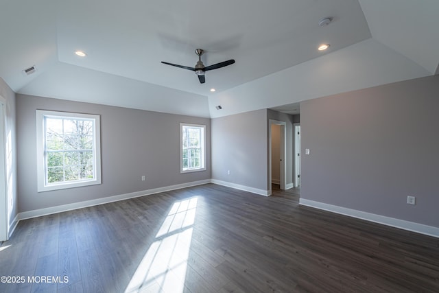 unfurnished room featuring ceiling fan, dark hardwood / wood-style floors, and vaulted ceiling