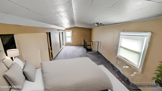 carpeted bedroom with vaulted ceiling