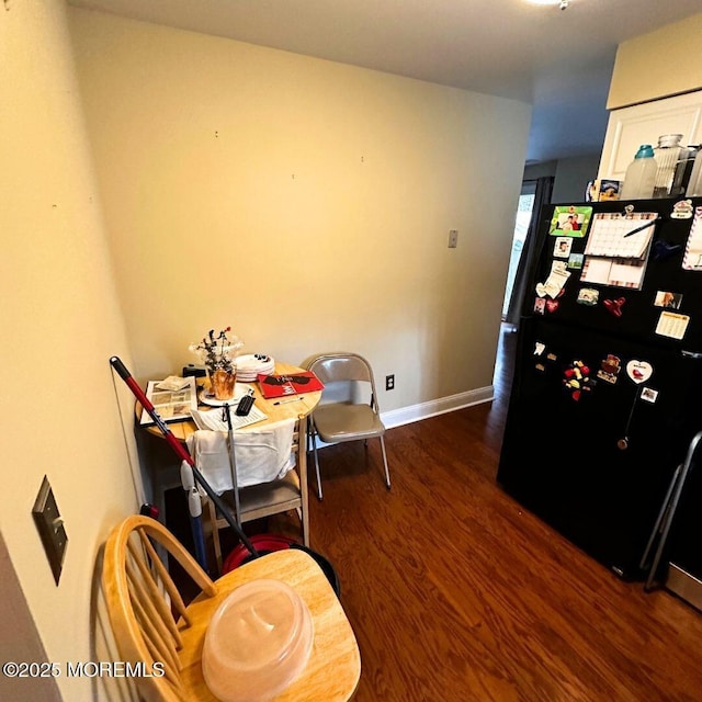 dining space with dark hardwood / wood-style floors