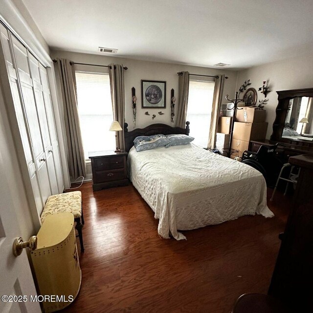 bedroom with a closet and dark hardwood / wood-style floors