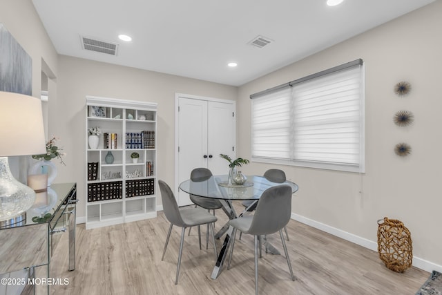 dining space featuring light wood-type flooring