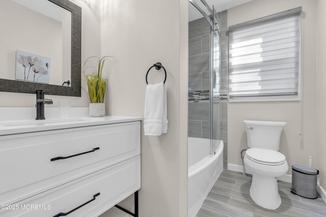 full bathroom with vanity, toilet, and tiled shower / bath