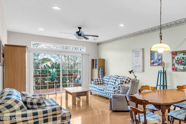 living room with ceiling fan and light hardwood / wood-style flooring