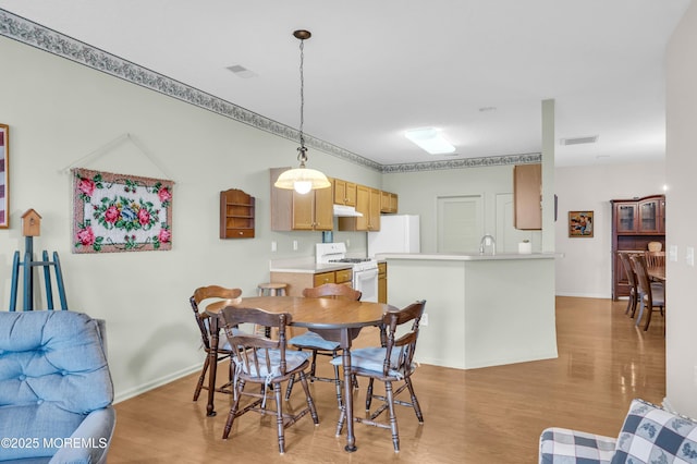 dining space featuring light hardwood / wood-style floors and sink