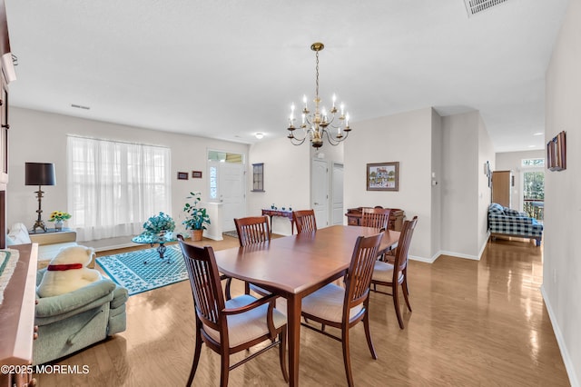 dining room featuring hardwood / wood-style flooring and a notable chandelier