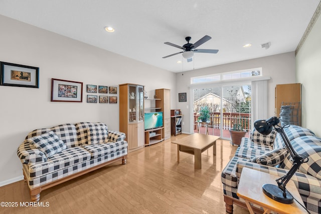 living room with ceiling fan and light wood-type flooring