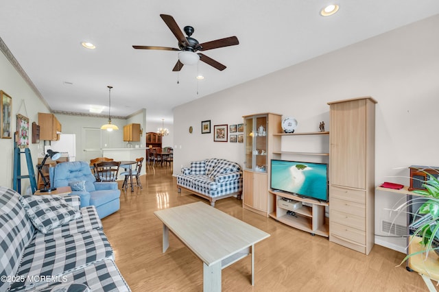 living room featuring ceiling fan, light hardwood / wood-style flooring, and ornamental molding