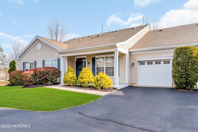 single story home featuring a front lawn and a garage