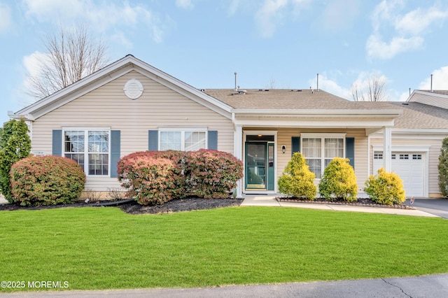 ranch-style home with a front yard and a garage