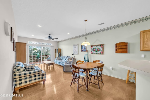 dining area featuring light wood-type flooring and ceiling fan