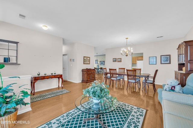 living room featuring light hardwood / wood-style flooring and a chandelier