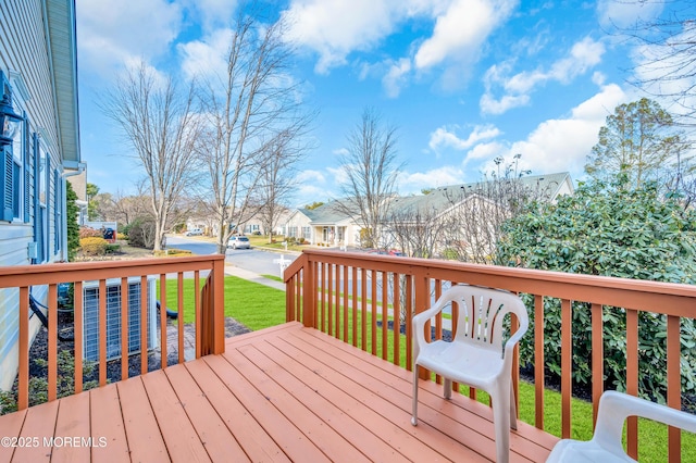 wooden terrace featuring a lawn