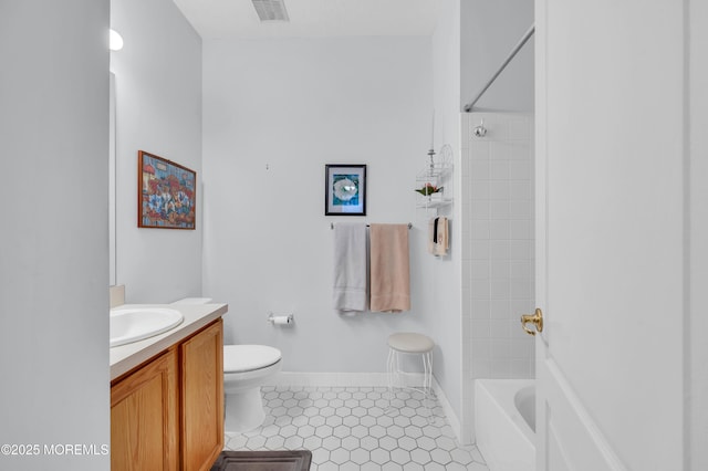 full bathroom featuring vanity, tiled shower / bath combo, tile patterned floors, and toilet