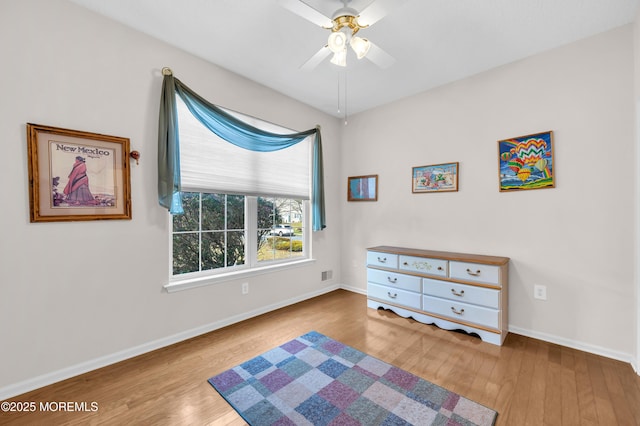 bedroom with ceiling fan and light hardwood / wood-style floors