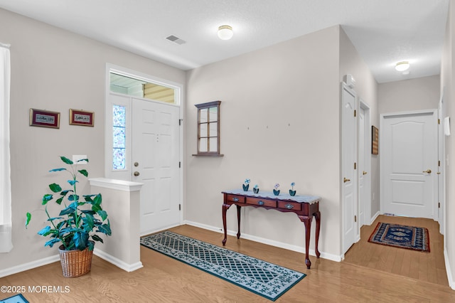 entrance foyer with a textured ceiling and hardwood / wood-style floors