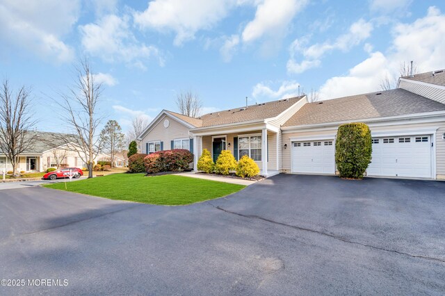 single story home with a front yard and a garage