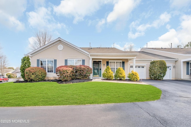 ranch-style home with a front lawn and a garage