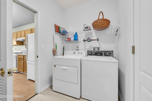 clothes washing area with independent washer and dryer