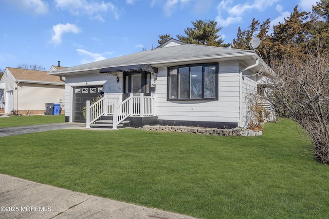 view of front of property with a front yard and a garage