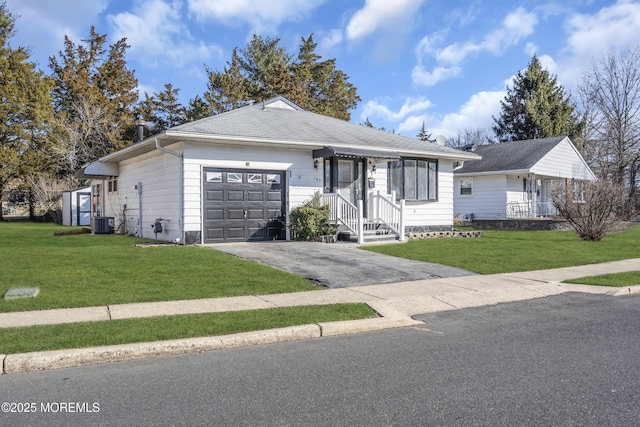 single story home with cooling unit, a garage, and a front yard