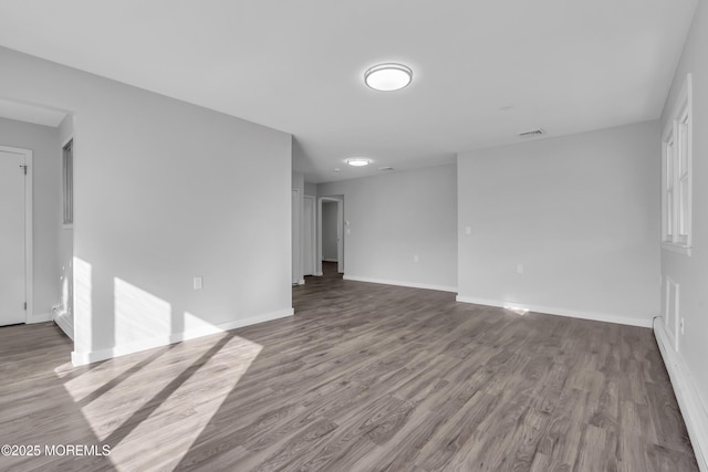 unfurnished room with hardwood / wood-style floors