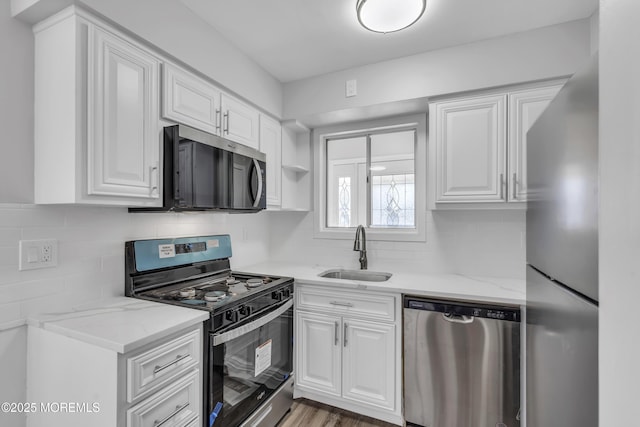 kitchen featuring white cabinets, sink, and stainless steel appliances