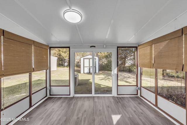 unfurnished sunroom with lofted ceiling