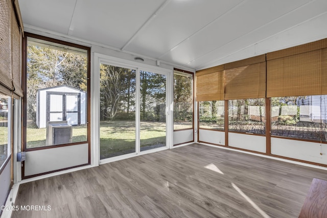 unfurnished sunroom with a healthy amount of sunlight and vaulted ceiling