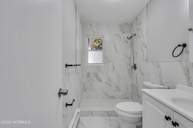 bathroom featuring toilet, baseboard heating, a tile shower, and vanity