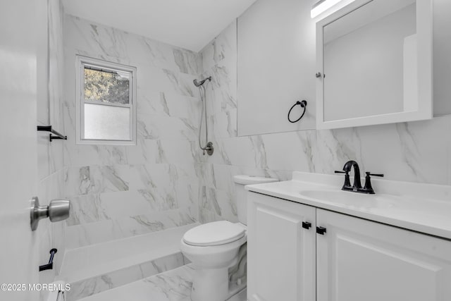 bathroom featuring toilet, vanity, tile walls, decorative backsplash, and a tile shower