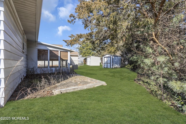 view of yard with a sunroom and a storage unit